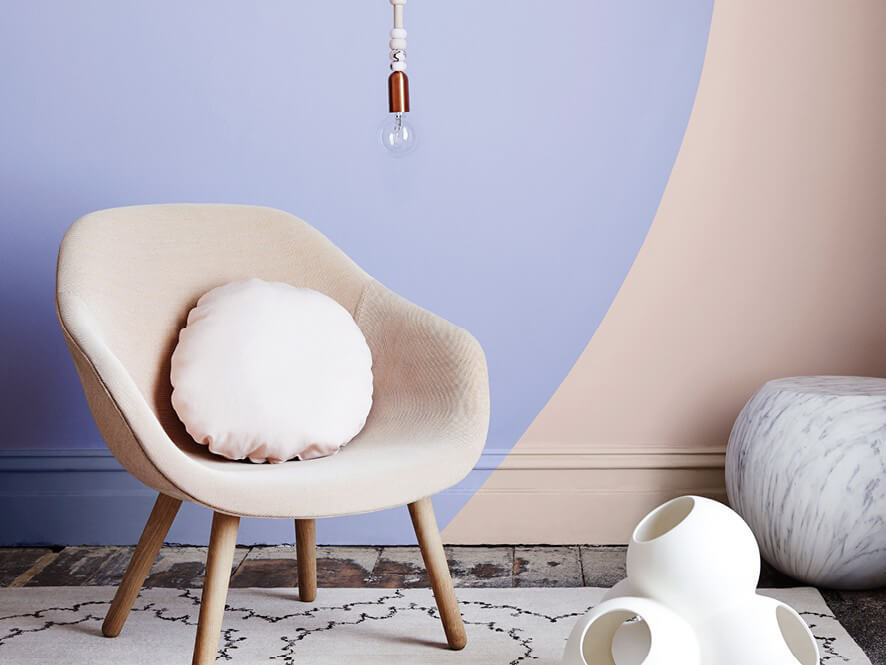 Purple lavender and Beige feature wall with chair and cushion with wooden floor and rug